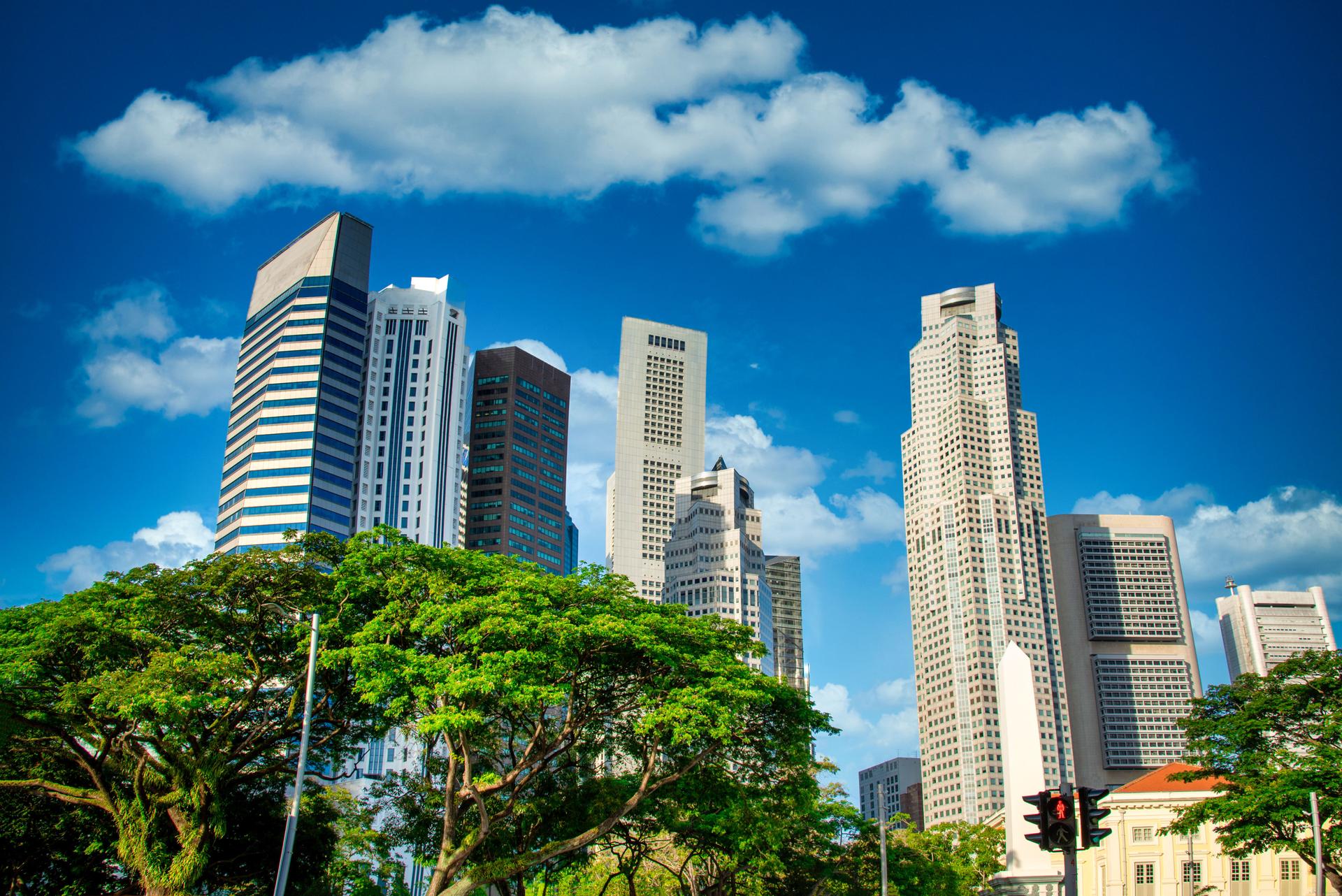 Singapore city skyline of business district downtown on blue sky with cloud in daytime.